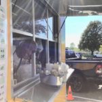leaning out window of vegan food truck minneapolis st paul